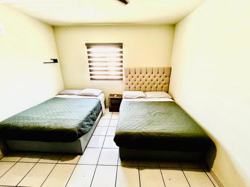 Una cama o camas en una habitación de Visita EXPRESS