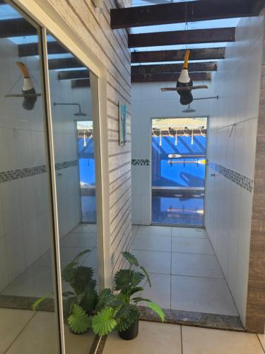 a hallway of a house with a ceiling fan at Casa luxo Maricá in Maricá