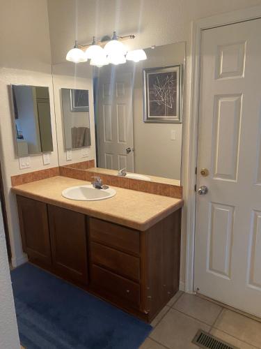 a bathroom with a sink and a large mirror at Parker Pair - Sunset Escape in Parker