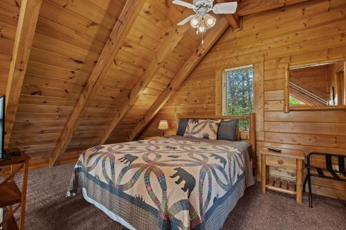 a bedroom with a bed in a log cabin at Escape to the Smokies- Pool, hot tub, cozy cabin, Pigeon Forge in Pigeon Forge
