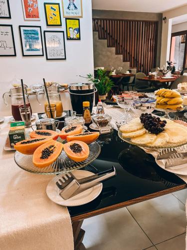 a table with oranges and other food on it at Amarilis Pousada Arraial d'Ajuda in Arraial d'Ajuda