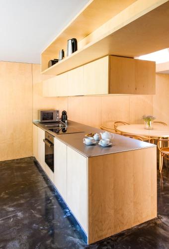 a kitchen with a counter top and a table at Melgaço Alvarinho Houses in Melgaço