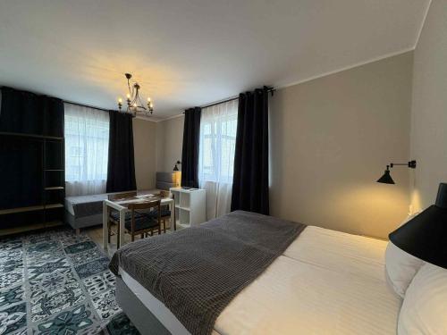 a bedroom with a bed and a table and a desk at Dom na Północy in Władysławowo