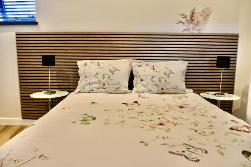 a bedroom with a bed with flowers on it at Costa C en E in Noordwijk
