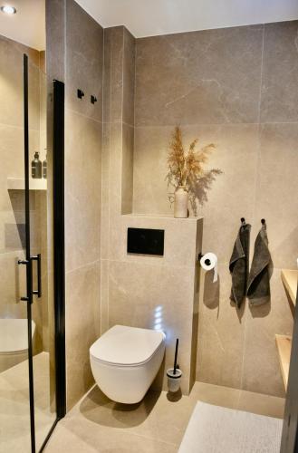 a bathroom with a toilet and a toilet paper roll at Costa C en E in Noordwijk