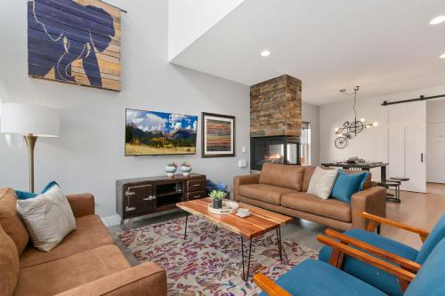 a living room with a couch and a table at The Cycle Haus Rooftop Deck with Hot Tub and Views in Fort Collins
