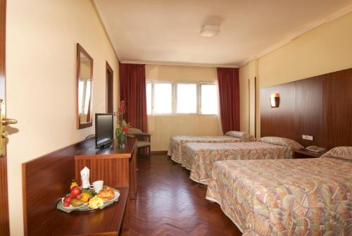 Postel nebo postele na pokoji v ubytování Hotel Galaico