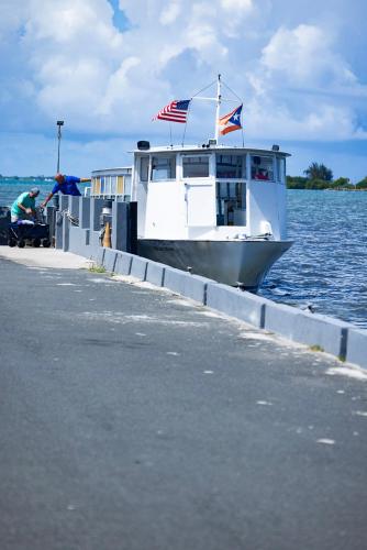 a boat is docked at a dock on the water at Isleta Marina- Paraíso Costero in Fajardo