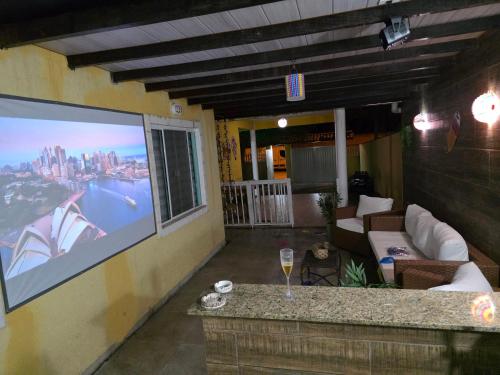 a large screen tv on the side of a building at Casa luxo Maricá in Maricá