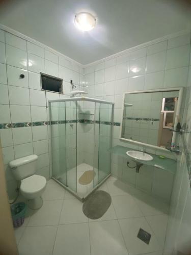 a bathroom with a shower and a toilet and a sink at Pousada Girassol in Rio de Janeiro