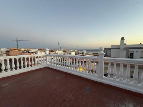 a balcony with a white railing and a view of the ocean at La Brisa de Tarik Rooms in Tarifa