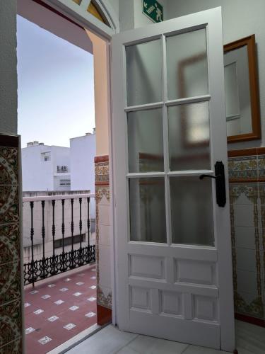 an open door in a room with a balcony at La Brisa de Tarik Rooms in Tarifa