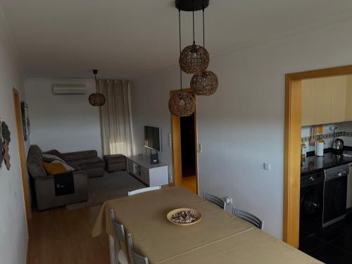 a kitchen and living room with a table and a couch at Urban Oasis in Mealhada