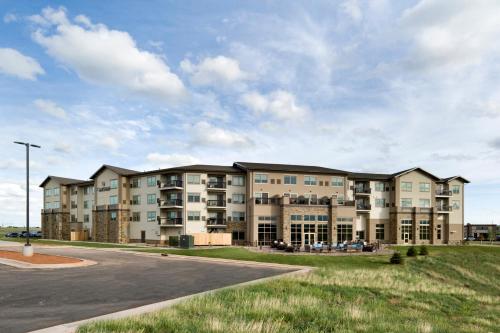 an exterior view of a apartment building at ClubHouse Hotel & Suites Rapid City in Rapid City