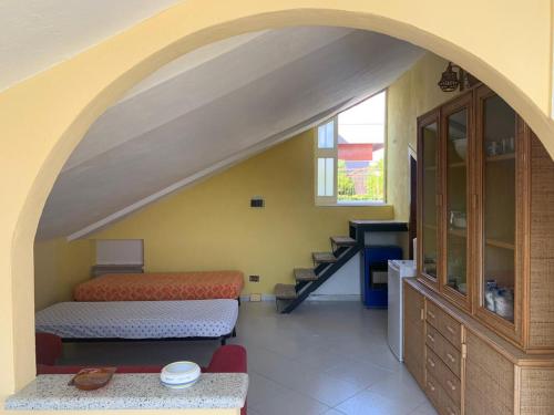 an archway in a room with a bed and a staircase at Villa Panorama in Acquavella