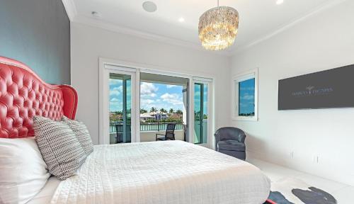 a bedroom with a large bed with a red headboard at Meridian Blu in Marco Island