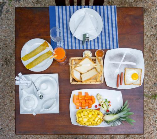 a table with a tray of food and plates of food at Mandavilla Airport Transit Hotel in Katunayake