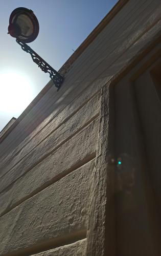 a street light on the side of a building at CALEO Guest House in Taurisano