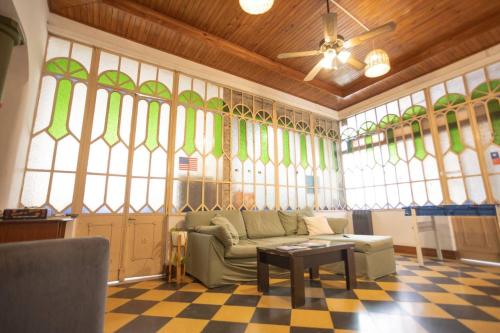 a living room with a couch and stained glass windows at Coliving en Junin Habitacion Simple en Hostel in Junín