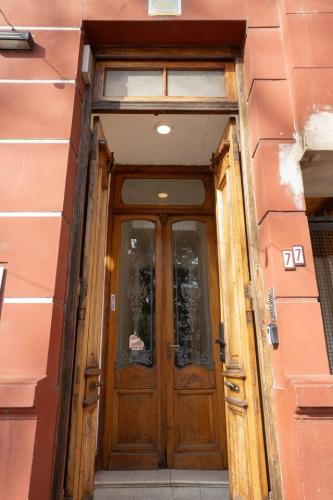 a wooden door of a building with a window at Coliving en Junin Habitacion Simple en Hostel in Junín