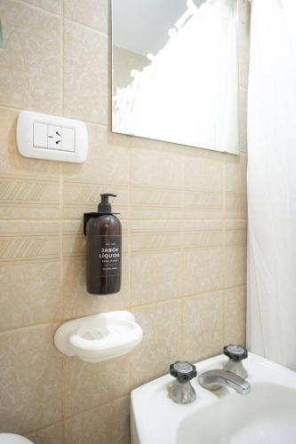a bathroom with a soap dispenser and a sink at Coliving en Junin Habitacion Simple en Hostel in Junín