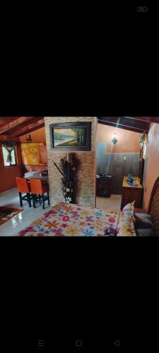 a bedroom with a large bed and a dining room at Cabañas Ángela in Mazamitla