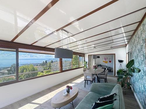 a living room with a couch and a table at Riviera House Montreux, un lieu magique ! in Montreux