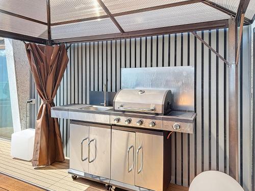 a kitchen with a grill on a patio at Riviera House Montreux, un lieu magique ! in Montreux