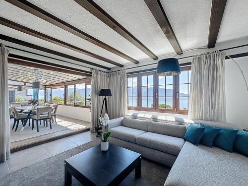 a living room with a couch and a table at Riviera House Montreux, un lieu magique ! in Montreux