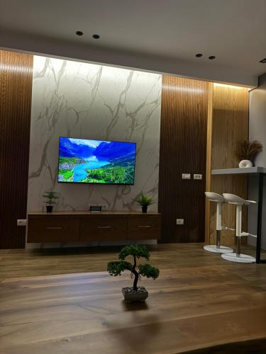 a living room with a flat screen tv on a wall at Luxury Suite21 in Korçë