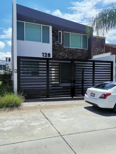 a white car parked in front of a house at Casa Canteras in Aguascalientes