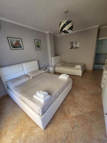 a bedroom with a large white bed and a couch at Roan's apartament in Golem