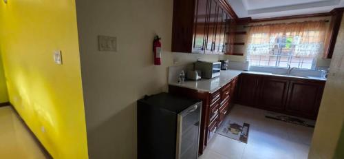 a small kitchen with a sink and a microwave at Harmony Croft's Hill in Crofts Hill