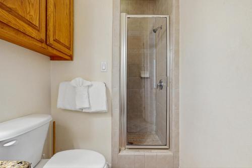a bathroom with a shower with a white toilet at Escape Condominiums #2 in South Padre Island