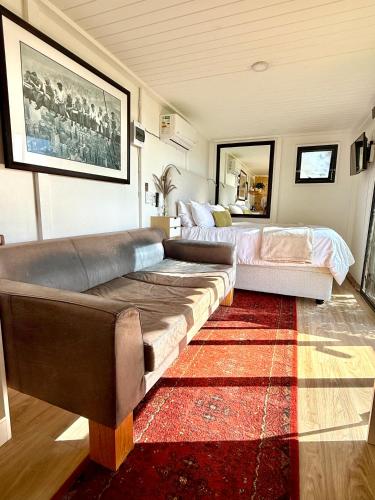 a living room with a couch and a bed at The Bachelor in Mossel Bay