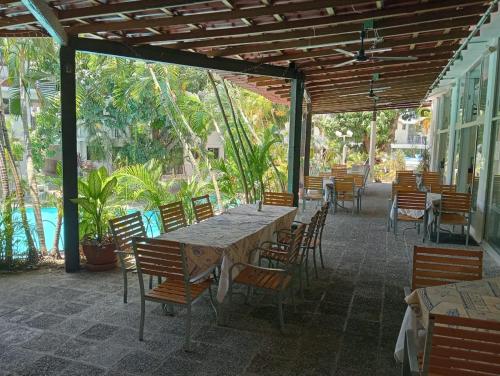 a table and chairs on a patio with a table and chairs at Alba Suites Acapulco in Acapulco