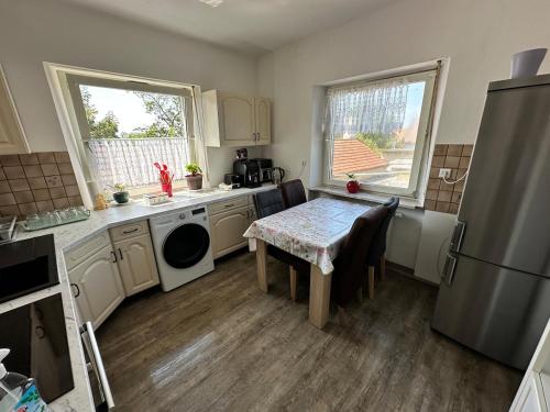 a small kitchen with a table and a refrigerator at Double room and shared bathroom in Nürnberg
