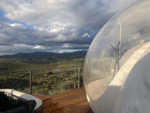 a glass ball sitting on a wooden deck with a view at Cabañas De Madera Y Bungalows - Gilmañas 3 in La Iruela