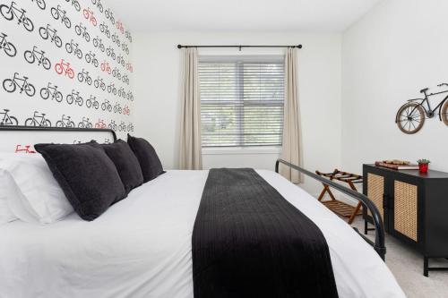 a bedroom with a bed and a bicycle wall at Little 5 Condo King Beds Ping-pong Garage in Bloomington
