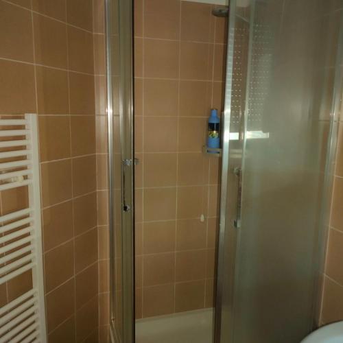 a bathroom with a shower with a glass door at Appartamento Sutri con posto auto riservato in Sutri