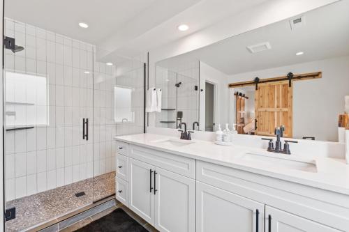 a white bathroom with two sinks and a shower at Quarry B8 in Whitefish