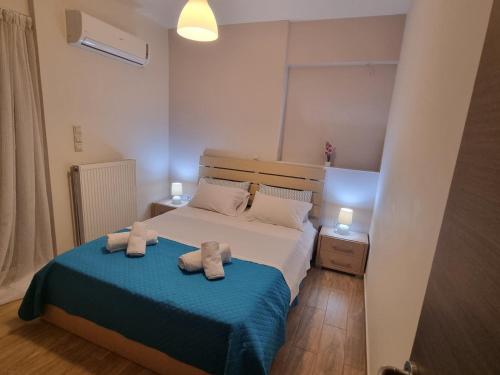 a bedroom with a bed with two towels on it at Onda Blu Deluxe Loutraki in Loutraki