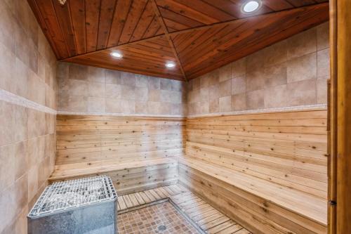 a sauna with wood paneling and a wooden ceiling at Grizzly Den in Whitefish