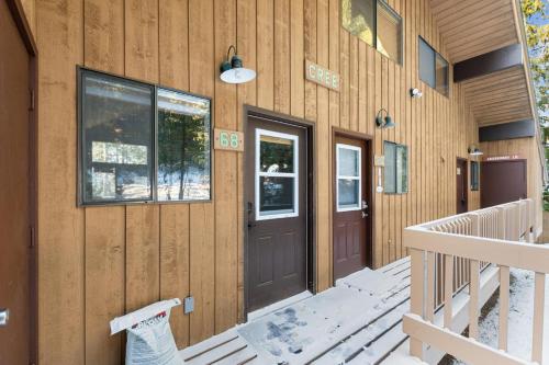 a wooden house with a door and a porch at Grizzly Den in Whitefish