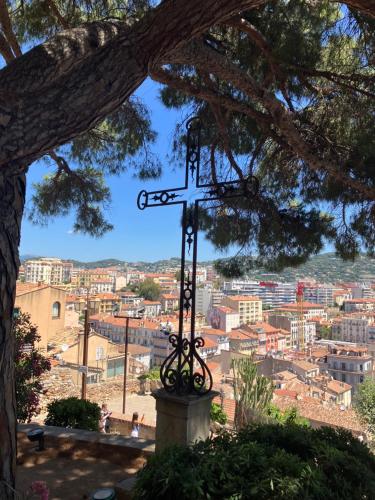 a cross on a hill with a view of a city at Studio à Cannes quartier du Suquet in Cannes