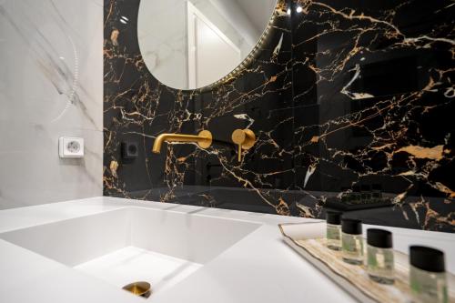 a bathroom with a mirror and a sink at Art 80 - A2 in Artemida
