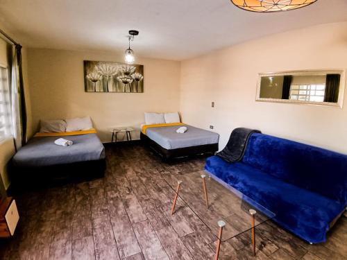 a living room with two beds and a couch at Yellow breeze loft, Paseo Durango in Durango