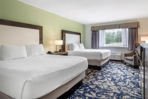 a hotel room with two beds and a window at Best Western West Greenwich Inn in West Greenwich