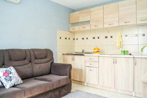 a living room with a couch and a kitchen at Apartments Bućin in Kotor