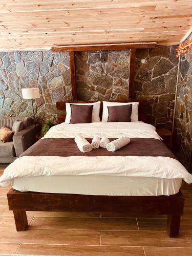a bedroom with a large bed with two towels on it at Ayder Luxury Villas & Bungalows in Çamlıhemşin